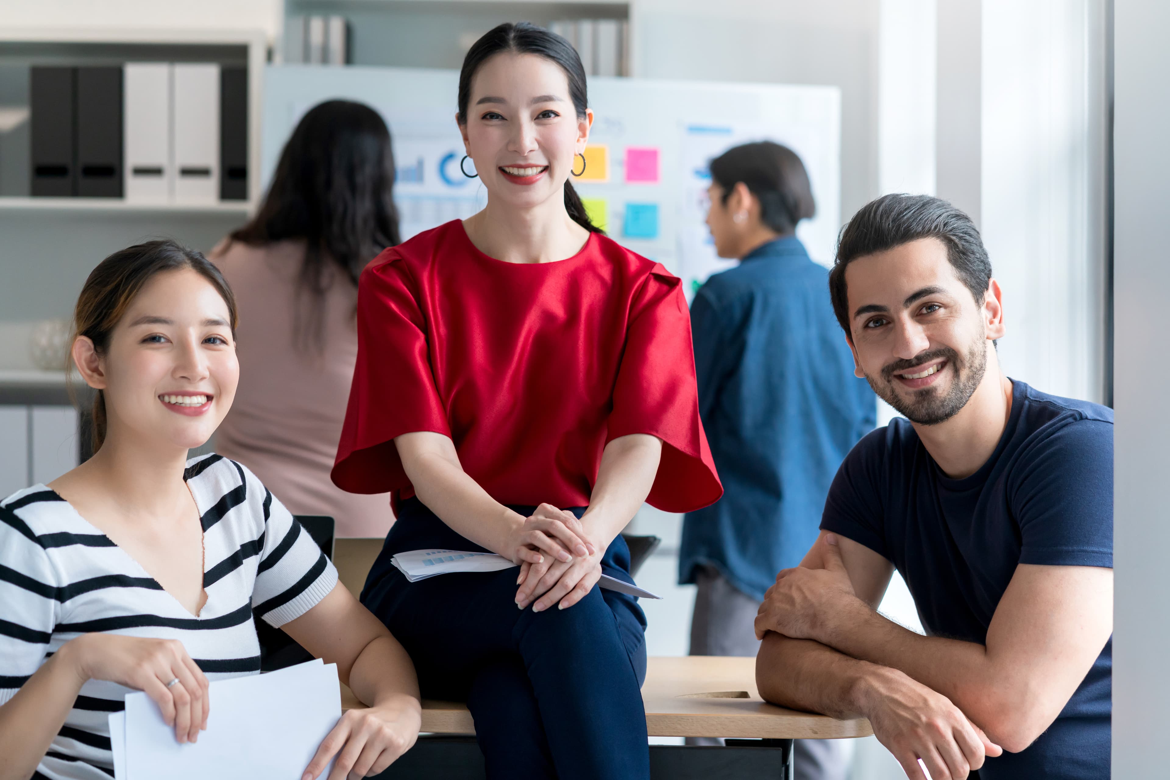 Group of four young professionals collaborating in office setting